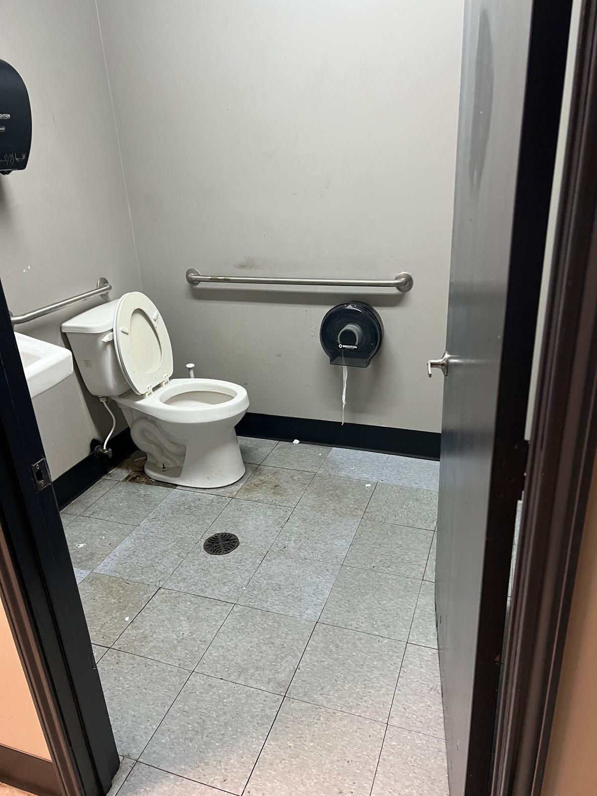 Restroom before flooring update with gray tile