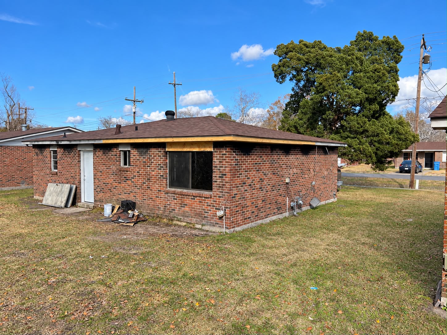 Brick home with repaired roofline, fascia, and soffit