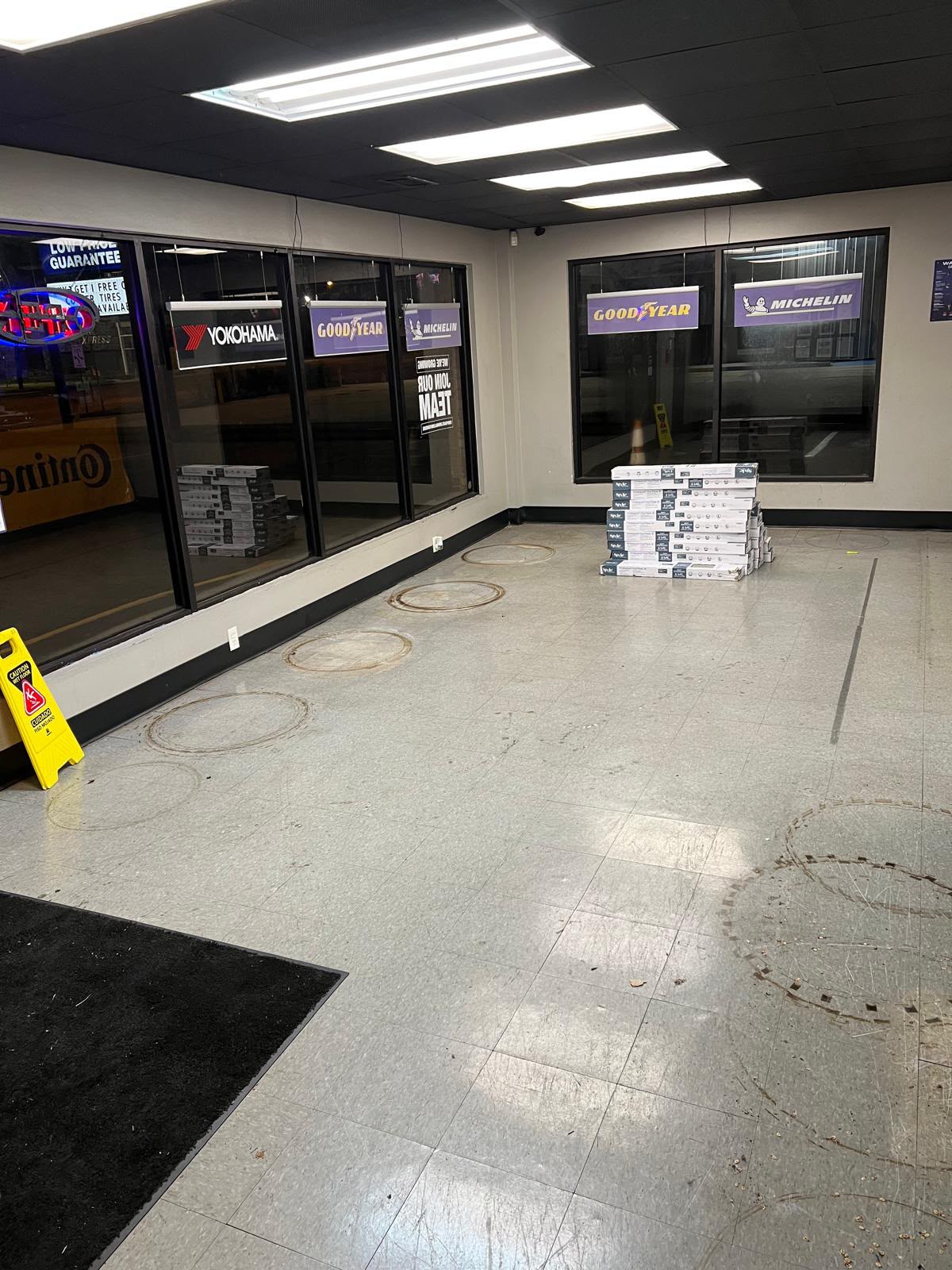 Showroom before flooring update with worn tile